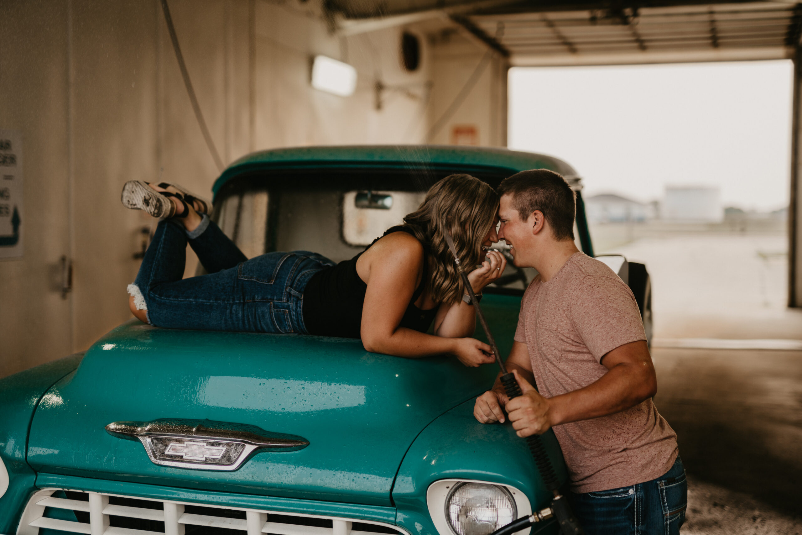 Creating a unique engagement photography session with a sexy car wash photo shoot including a vintage Chevrolet truck.