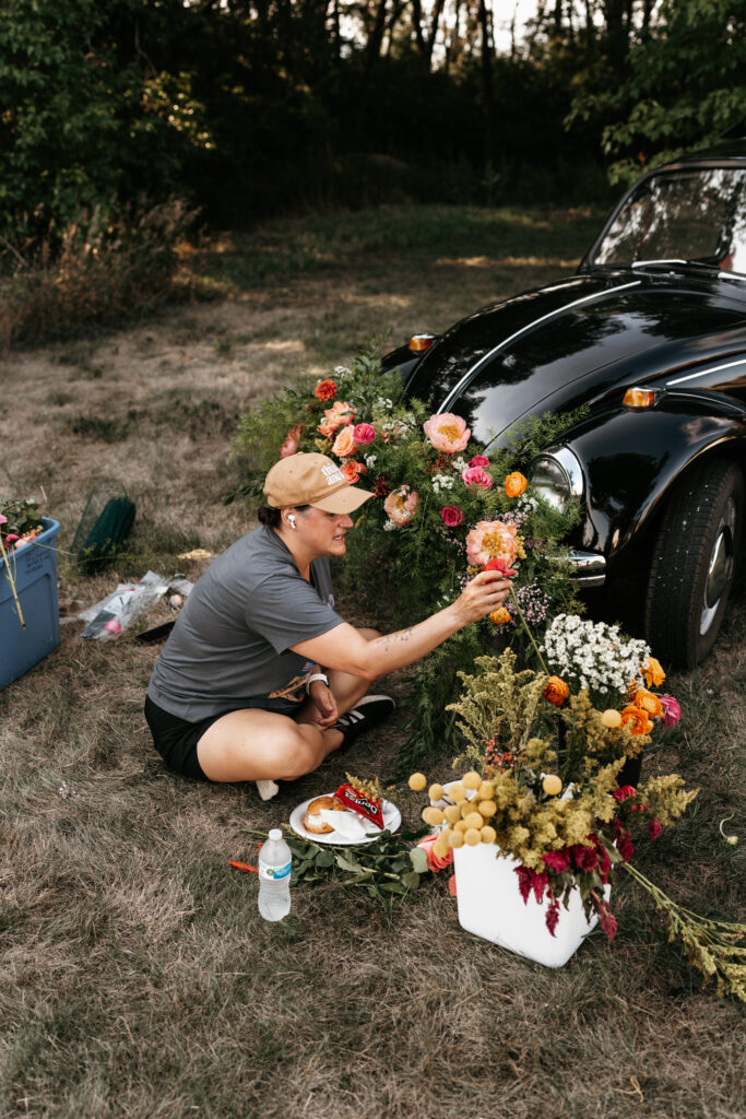 Jaime with Thistle & Dot putting flowers on the Volkswagen Beetle